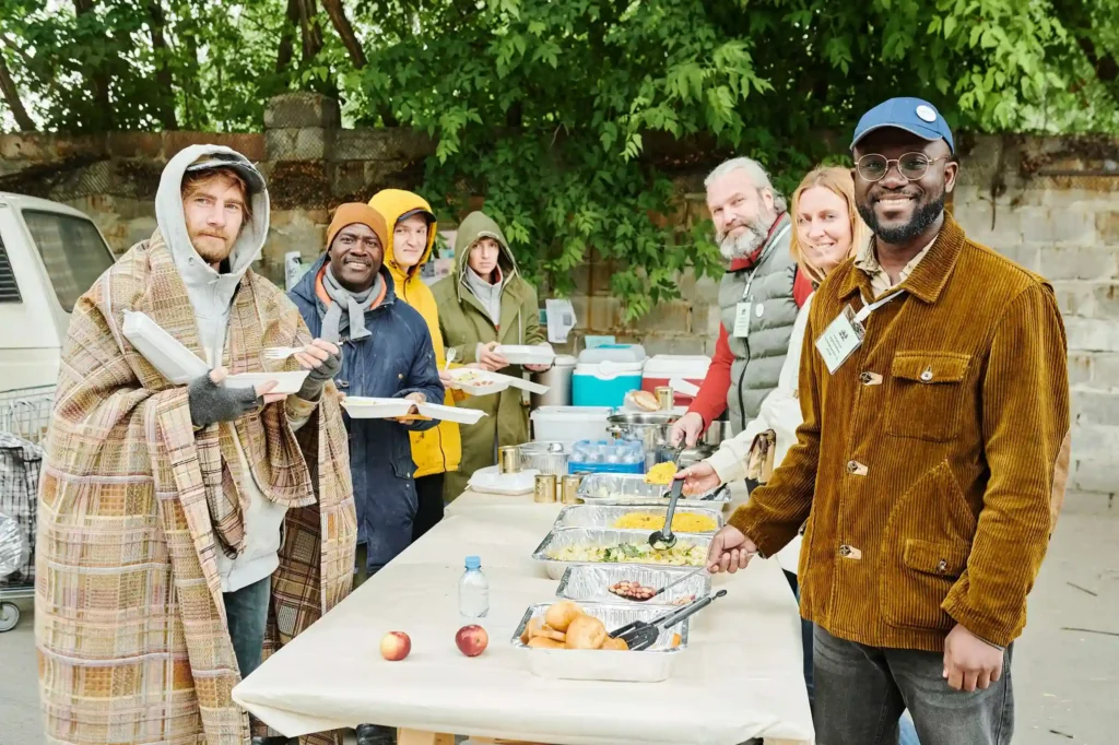People being fed by volunteers